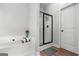 Bright bathroom featuring a soaking tub and glass-enclosed shower with modern fixtures at 243 Summergate Ln, Villa Rica, GA 30180