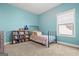 Stylish bedroom featuring blue walls, carpeted floors, a comfy bed, and a bookshelf at 243 Summergate Ln, Villa Rica, GA 30180