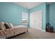 Blue bedroom with a window, double door closet, and a metal bed frame at 243 Summergate Ln, Villa Rica, GA 30180
