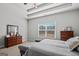 This bedroom features a cozy bed, a tray ceiling, and a large window at 243 Summergate Ln, Villa Rica, GA 30180