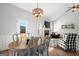 Bright dining area with a chandelier, views of the backyard, and comfortable seating at 243 Summergate Ln, Villa Rica, GA 30180