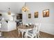 Charming dining room area with a decorative table set, seamlessly connecting to the well-appointed kitchen at 243 Summergate Ln, Villa Rica, GA 30180