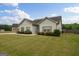 Well-maintained home featuring an attached garage and a nicely landscaped yard with lush greenery at 243 Summergate Ln, Villa Rica, GA 30180