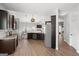 This is a kitchen with stainless steel appliances, granite counters, hardwood floors, and dark cabinets at 243 Summergate Ln, Villa Rica, GA 30180