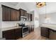 This is a kitchen with stainless steel appliances, granite counters, hardwood floors, and dark cabinets at 243 Summergate Ln, Villa Rica, GA 30180