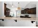 This is a kitchen with stainless steel appliances, granite counters, hardwood floors, and dark cabinets at 243 Summergate Ln, Villa Rica, GA 30180