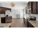 This is a kitchen with stainless steel appliances, granite counters, hardwood floors, and dark cabinets at 243 Summergate Ln, Villa Rica, GA 30180