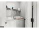 Efficient laundry room with washer, dryer, and shelving for storage at 243 Summergate Ln, Villa Rica, GA 30180