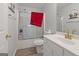 Well-lit bathroom featuring a shower-tub combo, white vanity, and modern fixtures at 85 Clairidge Ln, Lawrenceville, GA 30046