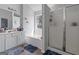 Bright bathroom featuring a bathtub, shower with glass doors, and a double vanity at 85 Clairidge Ln, Lawrenceville, GA 30046