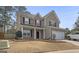 Charming two-story home with brick and siding, featuring a well-manicured lawn and attached two-car garage at 85 Clairidge Ln, Lawrenceville, GA 30046