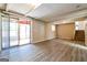 Finished basement with wood-look flooring, a sliding glass door, and staircase at 1343 Burbank Trl, Morrow, GA 30260