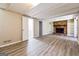 Finished basement with wood-look flooring and a brick fireplace with built-in shelving at 1343 Burbank Trl, Morrow, GA 30260