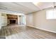 Finished basement featuring wood-look flooring, a brick fireplace, and built-in shelving at 1343 Burbank Trl, Morrow, GA 30260