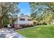 Split-level home showing a large driveway and well-kept lawn with mature trees at 1343 Burbank Trl, Morrow, GA 30260