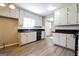 Classic kitchen with white cabinets, black countertops, and appliances, including modern flooring at 1343 Burbank Trl, Morrow, GA 30260