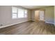 Bright living room featuring wood-look floors and natural light from a large window at 1343 Burbank Trl, Morrow, GA 30260