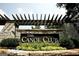 Entrance to The Canoe Club featuring a stone sign and lush landscaping at 415 Discovery Lake Dr, Fayetteville, GA 30215