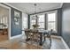 Dining room features a rustic table, hardwood floors, and modern chandelier at 415 Discovery Lake Dr, Fayetteville, GA 30215
