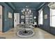 Formal dining room featuring a statement chandelier and dark teal trim and paneling at 415 Discovery Lake Dr, Fayetteville, GA 30215