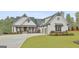 Beautiful two-story home with a well-manicured lawn, a two car garage and a cozy front porch at 415 Discovery Lake Dr, Fayetteville, GA 30215