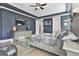 The spacious main bedroom features hardwood floors, tray ceiling, gray walls, and sitting area at 415 Discovery Lake Dr, Fayetteville, GA 30215