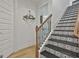 Stairway with decorative tiling, wood railing, and white walls at 415 Discovery Lake Dr, Fayetteville, GA 30215