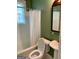 Traditional bathroom featuring a green wall, with a pedestal sink, tub, shower and toilet at 242 12Th St Ne 1 1A, Atlanta, GA 30309