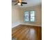 Cozy bedroom with gleaming hardwood floors and a window, great for relaxation and rest at 242 12Th St Ne 1 1A, Atlanta, GA 30309