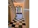 Inviting foyer features a checkered floor, grand staircase, and a doorway leading to the outside at 242 12Th St Ne 1 1A, Atlanta, GA 30309