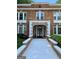 Charming red brick apartment building with white trim, a walkway, and well-maintained landscaping at 242 12Th St Ne 1 1A, Atlanta, GA 30309