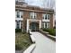 Charming red brick apartment building with white trim, a walkway, and well-maintained landscaping at 242 12Th St Ne 1 1A, Atlanta, GA 30309
