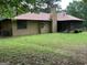 A spacious backyard with a screened porch and chimney, perfect for outdoor living at 1288 Lakewood Ne Dr, Conyers, GA 30013