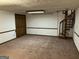View of the basement with brown carpet and spiral staircase at 1288 Lakewood Ne Dr, Conyers, GA 30013