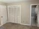 Spacious bedroom features a closet with louvered doors and an entry leading into an en-suite bathroom at 1288 Lakewood Ne Dr, Conyers, GA 30013