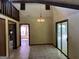 Open dining room with high ceilings, chandelier, and access to the patio at 1288 Lakewood Ne Dr, Conyers, GA 30013