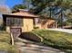 Image showcases the garage, and driveway surrounded by well-maintained landscaping at 1288 Lakewood Ne Dr, Conyers, GA 30013
