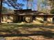 Image featuring the front exterior of the home with a well maintained lawn and stone accents at 1288 Lakewood Ne Dr, Conyers, GA 30013