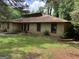 The home's front is enhanced by a well-kept lawn and stone-accented landscaping at 1288 Lakewood Ne Dr, Conyers, GA 30013