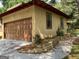 Exterior of the house with a wooden garage door and landscaped concrete driveway at 1288 Lakewood Ne Dr, Conyers, GA 30013