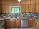 Kitchen featuring wood cabinets, granite countertops, and stainless steel appliances at 1288 Lakewood Ne Dr, Conyers, GA 30013