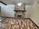 Spacious living room with stone fireplace, wood floors, and a ceiling fan at 1288 Lakewood Ne Dr, Conyers, GA 30013