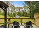 Backyard patio featuring mature trees, a shed, and an outdoor seating area at 2341 Elmwood Se Cir, Atlanta, GA 30339