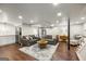 Large finished basement features two sofas, a stylish rug, and a wet bar, creating an inviting space at 2341 Elmwood Se Cir, Atlanta, GA 30339