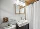 Modern bathroom featuring tiled walls, modern sink, vanity and a glass shower with a white shower curtain at 2341 Elmwood Se Cir, Atlanta, GA 30339