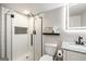 Bathroom featuring a tiled shower, granite countertop and an LED mirror at 2341 Elmwood Se Cir, Atlanta, GA 30339