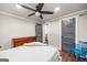 Well-lit bedroom with a stylish bed, ceiling fan, hardwood floors, and a dresser at 2341 Elmwood Se Cir, Atlanta, GA 30339