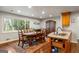 Bright dining room with large window, wooden table set, and elegant wood flooring at 2341 Elmwood Se Cir, Atlanta, GA 30339