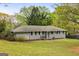 Single-story gray brick house with a well-kept lawn and garden, showing curb appeal at 2341 Elmwood Se Cir, Atlanta, GA 30339