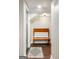 Hallway with hardwood floors, a cushioned bench and gray accent rug at 2341 Elmwood Se Cir, Atlanta, GA 30339